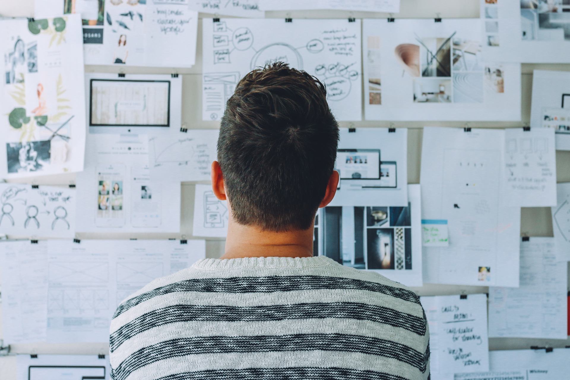 business owner looking at whiteboard notes