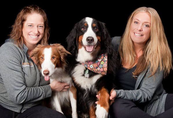 Jeanette and Nicole Farren with two dogs at DiggiddyDoggyDaycare